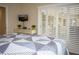Bedroom with queen bed, dresser and sliding doors to patio at 6772 Greenview Ln, Englewood, FL 34224