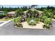 Community building with landscaped grounds and palm trees at 6772 Greenview Ln, Englewood, FL 34224