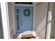 Inviting light blue front door with a wreath and welcome mat at 6772 Greenview Ln, Englewood, FL 34224