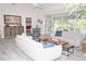Living room with comfortable seating, hardwood floors and access to pool at 6772 Greenview Ln, Englewood, FL 34224