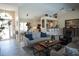 Open living room with hardwood floors, comfortable seating, and large windows at 6772 Greenview Ln, Englewood, FL 34224