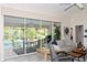 Bright living room with view of the pool and patio through sliding glass doors at 6772 Greenview Ln, Englewood, FL 34224