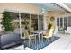 Covered patio with seating area and grill, ideal for outdoor dining at 6772 Greenview Ln, Englewood, FL 34224