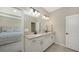 Double vanity bathroom with white cabinets and a large mirror at 11281 Beach Walk Ne Way, St Petersburg, FL 33716