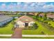 Single-Gathering home in a community with a pond, green spaces, and other homes at 4530 Trento Pl, Bradenton, FL 34211