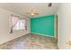 Bedroom with teal accent wall and wood-look flooring at 6519 Deerberry Ct, Lakewood Ranch, FL 34202