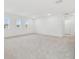 Spacious bonus room with carpeted floor and two windows at 12183 Stirrup Dr, Dade City, FL 33525