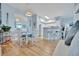 Light and airy dining area with white table and chairs, and kitchen view at 4126 Central Sarasota Pkwy # 2026, Sarasota, FL 34238