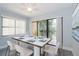 Bright dining area with sliding glass doors leading to balcony at 425 30Th W Ave # C201, Bradenton, FL 34205