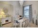 Elegant dining room with a white table, six chairs, and a chandelier at 15923 29Th E St, Parrish, FL 34219