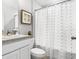 Clean bathroom with white vanity, shower/tub combo, and patterned shower curtain at 5146 Lawton Ave, North Port, FL 34288