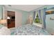 Bedroom with a queen bed and ocean-themed bedding at 5333 Kelly Dr # 6, Sarasota, FL 34233