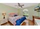 Bedroom with a queen bed, large window, and hardwood floors at 5333 Kelly Dr # 6, Sarasota, FL 34233