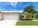 White house with a two-car garage and well-manicured lawn at 5333 Kelly Dr # 6, Sarasota, FL 34233