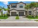 Two-story townhome with gray exterior, two-car garage, and landscaped front yard at 15064 Lyla Ter, Bradenton, FL 34211