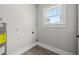 Bright laundry room with vinyl flooring and a window at 2416 7Th W Ave, Bradenton, FL 34205