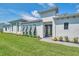 Modern home with gray shutters and landscaped lawn at 5932 Red Mangrove Ln, Bradenton, FL 34210