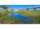 Ground level view of condo with pond and lush landscaping at 4731 Independence Dr # 4731, Bradenton, FL 34210