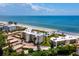 Aerial view of beachfront condo building with ocean and beach views at 4825 Gulf Of Mexico Dr # 105, Longboat Key, FL 34228