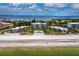 Aerial view of beachfront condo community with pool and lush landscaping at 4825 Gulf Of Mexico Dr # 105, Longboat Key, FL 34228