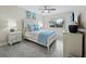 Bright bedroom with light blue bedding and ensuite bathroom access at 4825 Gulf Of Mexico Dr # 105, Longboat Key, FL 34228