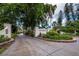 Landscaped entryway to The Westchester community, featuring a brick sign and flag at 4825 Gulf Of Mexico Dr # 105, Longboat Key, FL 34228