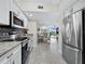 Open concept kitchen with stainless steel appliances and granite countertops at 4825 Gulf Of Mexico Dr # 105, Longboat Key, FL 34228