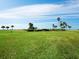 Expansive grassy lawn area with tropical landscaping and ocean views at 4825 Gulf Of Mexico Dr # 105, Longboat Key, FL 34228