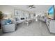 Bright living room with tiled floors, comfy seating, and large TV at 4825 Gulf Of Mexico Dr # 105, Longboat Key, FL 34228