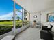 Spacious screened porch with ocean views and comfy wicker furniture at 4825 Gulf Of Mexico Dr # 105, Longboat Key, FL 34228