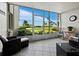 Relaxing screened porch with ocean views and comfy wicker furniture at 4825 Gulf Of Mexico Dr # 105, Longboat Key, FL 34228
