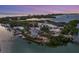 Sunset aerial view of waterfront property with marina and bridge at 5732 Puccini St, Nokomis, FL 34275