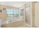 Spa-like bathroom with a large soaking tub and walk-in shower at 4931 Oxford Dr, Sarasota, FL 34242