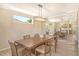 Bright dining room with large table, chandelier, and mirrored wall reflecting kitchen at 4931 Oxford Dr, Sarasota, FL 34242