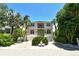 Two-story house with a light peach exterior, two-car garage, and landscaping at 4931 Oxford Dr, Sarasota, FL 34242