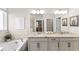 Double vanity bathroom with soaking tub and large mirror at 7291 Great Egret Blvd, Sarasota, FL 34241