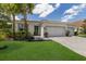 Single-story home with two-car garage, landscaping, and paver driveway at 7291 Great Egret Blvd, Sarasota, FL 34241