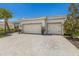 Two-car garage, paver driveway, and attractive landscaping at 7291 Great Egret Blvd, Sarasota, FL 34241