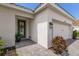 Front entry with paver walkway, potted plants, and a modern door at 7291 Great Egret Blvd, Sarasota, FL 34241