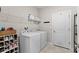 Laundry room with washer, dryer, and ample shelving at 7291 Great Egret Blvd, Sarasota, FL 34241