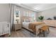 Main bedroom with wood-look floors and cozy bedding at 7291 Great Egret Blvd, Sarasota, FL 34241