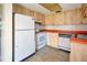 Compact kitchen featuring wood cabinets and orange countertops at 22481 Westchester Blvd # B44, Port Charlotte, FL 33980