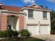 Two-story house with two-car garage, red tile roof and landscaped entry at 7618 Marsh Orchid Cir # 7618, Bradenton, FL 34203