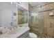 Bathroom with glass shower and tiled walls at 1900 Gulf N Dr # 4, Bradenton Beach, FL 34217