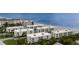 Aerial view of condo buildings situated directly on the beach, offering stunning ocean views at 2810 N Beach Rd # 106, Englewood, FL 34223