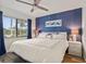 King-size bed, blue accent wall, and hardwood floors in this main bedroom at 2810 N Beach Rd # 106, Englewood, FL 34223