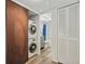 Stackable washer and dryer in a well-lit laundry room at 2810 N Beach Rd # 106, Englewood, FL 34223