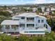 Modern waterfront home with pool and expansive patio, offering stunning views at 705 Jungle Queen Way, Longboat Key, FL 34228