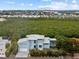 Contemporary waterfront home with attached two-car garage and manicured lawn at 705 Jungle Queen Way, Longboat Key, FL 34228