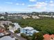 Aerial view of a waterfront home showcasing its unique architectural design and location at 705 Jungle Queen Way, Longboat Key, FL 34228